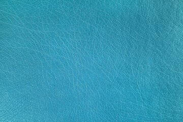Fototapeta na wymiar Natural, artificial turquoise leather texture background. Material for sport items, clothes, furnitre and interior design. ecological friendly leatherette.