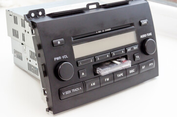 Old car audio CD and cassette player 2 DIN. On a lite background