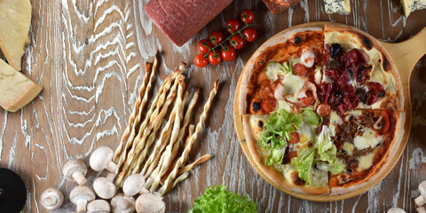 Assortment of four pizzas - margherita, four types of cheese, salami, pizza with mushrooms. Backgroundu. Top view