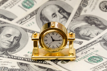 Time is money. Gold watch on 100 dollar bills. The concept of the transience of time