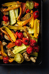 Roasted sliced vegetables on a baking tray.