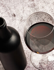 red wine served in a crystal glass with a bottle beside it and corkscrew