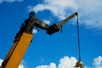 Close up of a yellow crane lifting goods