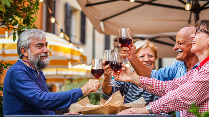 Group of old people eating and drinking outdoor