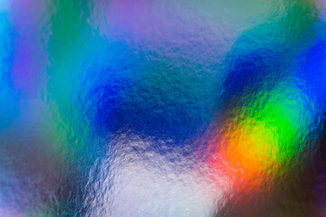 Colorful holographic iridescent holo bg texture, blue, green and orange abstract background