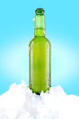 Refreshing cold beer in the snow. Bottle of water with drops and ice. Melted water on a bottle. Vertical frame.
