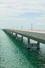 'Seven mile bridge crossing tropical waters of Moser channel under cumulus clouds in the Florida Keys'