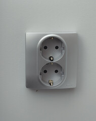 isolated white gray socket on a light background, space for text. concept of electronics renovation renovation apartment sockets kitchen