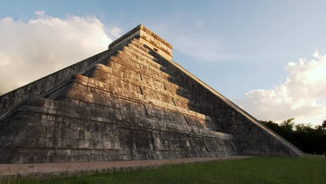 View from below of temple of Kukulcan (El Castillo) lightened with sun, the center of the archeological site in Chichen Itza, a city built by the Maya people of Terminal Classic period. No tourists