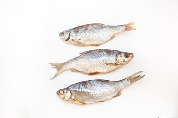Dry fish. Seafood snack for beer. Salted sun-dried, jerked or smoked fish. Taranka, vobla. Russian or Ukrainian food. Caspian roach fish. Dead fish. High resolution photo. On white background