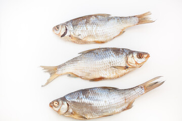 Dry fish. Seafood snack for beer. Salted sun-dried, jerked or smoked fish. Taranka, vobla. Russian or Ukrainian food. Caspian roach fish. Dead fish. High resolution photo. On white background