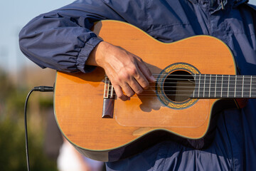 Fototapeta premium The hand of a man playing classical guitar
