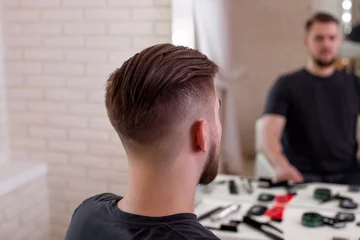  Male head with stylish haircut on barbershop background © Galina