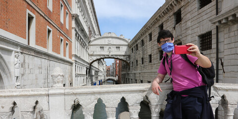 Young tourist with mask during lockdown in Venice in Italy in Southern Europe