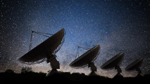 Many radar telescopes at night observing signal from stars.