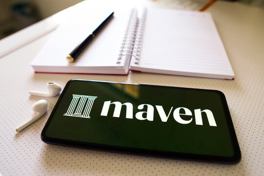 July 1, 2022, Brazil. In this photo illustration the Maven logo seen displayed on a smartphone next to a book, pen and headphones.