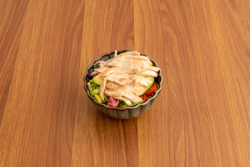 Salad with chopped grilled chicken fillet, lettuce and tomatoes and edamame beans
