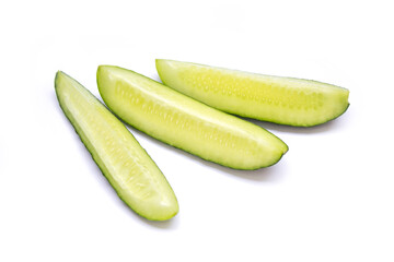 The sliced cucumbers are lying on a white background
