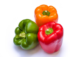 three different colors of peppers: red pepper, green pepper and yellow pepper