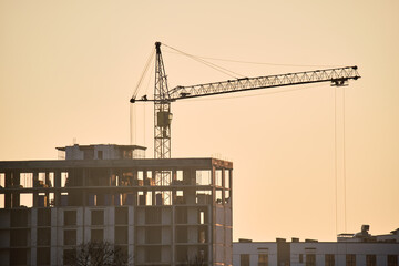 Tower crane at high residential apartment buildings construction site. Real estate development