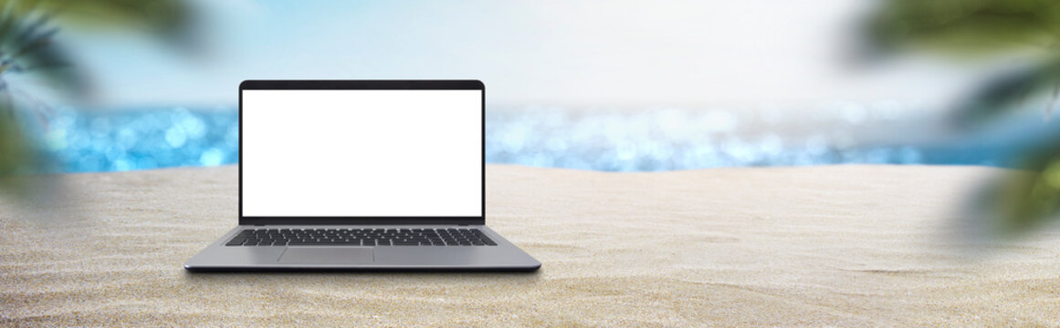 laptop on a beautiful beach - vacation work concept