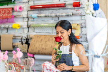 woman in her flower shop with a beautiful flower