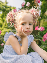Little girl in the rose garden.