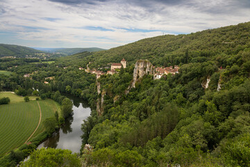 Fototapeta na wymiar Panoramic view of Saint Cirq la popie with a forest and a river. Medieval village. Most beautiful villages in France