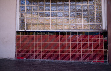 Art Deco Wall of Red and Black Tiles and Glass Block Translucent Windows.