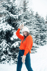 Fototapeta na wymiar Woman in snowy forest. Winter vacation.