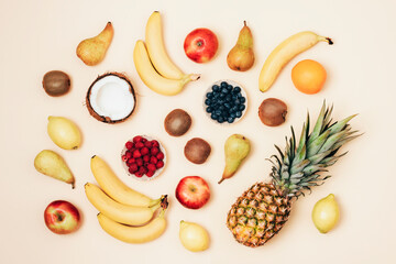 Various fruits on yellow background. Top view, flat lay. Tropical fruits, vegan food, healthy diet