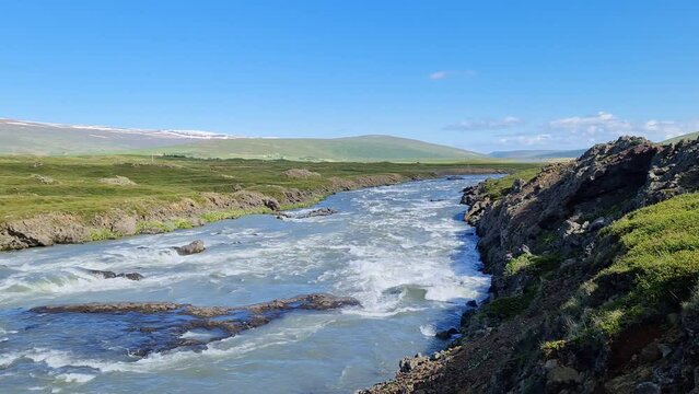 Fantastic landscape with flowing rivers and streams with rocks and grass in Iceland.