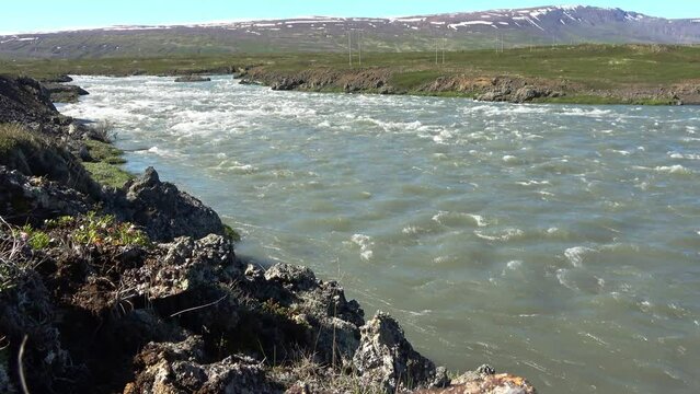 Fantastic landscape with flowing rivers and streams with rocks and grass in Iceland.