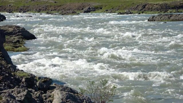 Fantastic landscape with flowing rivers and streams with rocks and grass in Iceland.