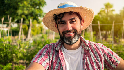 Portrait of modern bearded farmer man take break with hoe in agricultural field