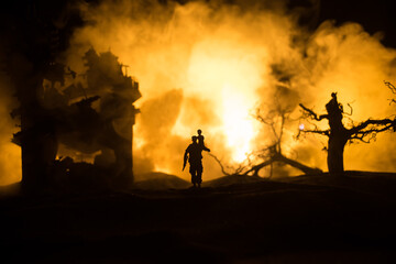 Silhouette soldier carrying little boy on his shoulder from fire. Rescue savior concept. Man moving...