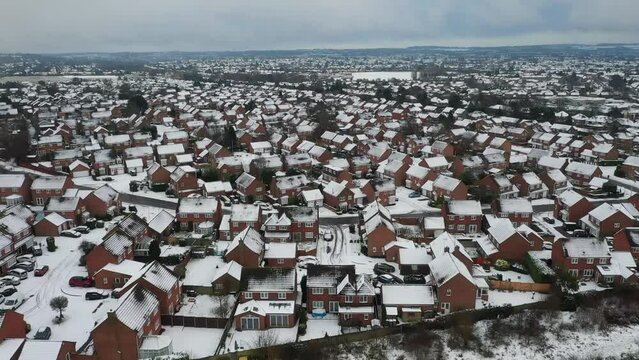 Aerial panorama of densely arranged houses with snow-covered roofs