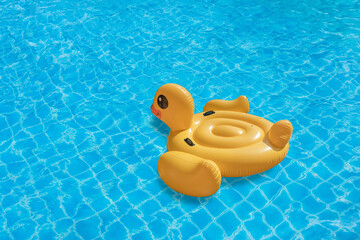 Duck shaped inflatable ring on swimming pool. Concept for summer day