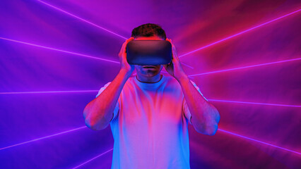 man using 3D virtual reality headset going into cyberspace playing video game