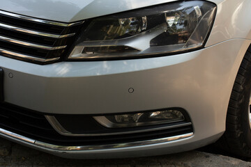 Leftist front wheel and headlight. Replicas of Russian cars. Halogen lighting at the white car.