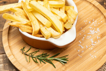 Tasty french fries on plate on bowl
