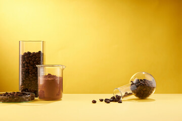 Front view of coffee decorated in transparent podium and glassware laboratory equipment yellow background
