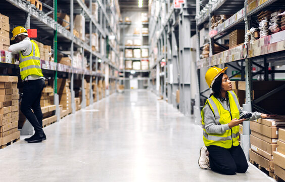 Portrait of african american engineer woman scanning package with barcode scanner check goods in transportation and distribution in warehouse.logistic Industrial and business export