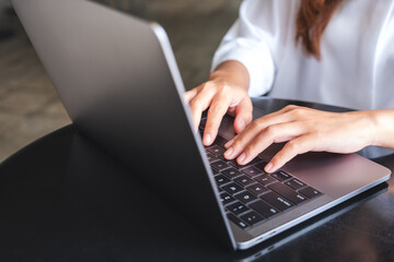 Closeup image of hands typing on laptop computer keyboard