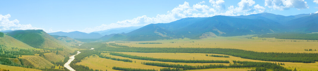 Beautiful panoramic landscape of mountains, golden steppe and green forest, banner format