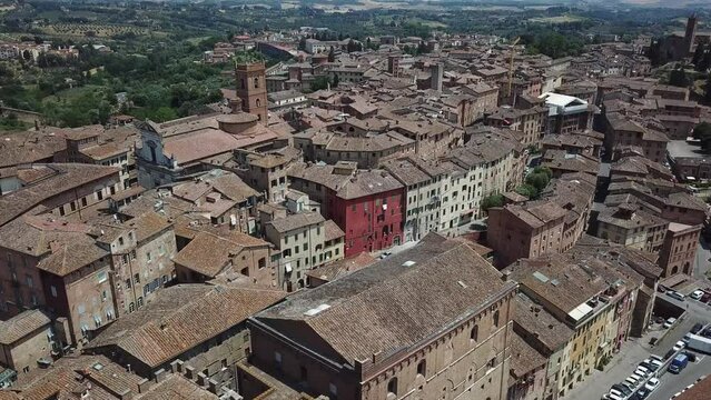 Drone establishing shot in Italian village. Drone in Tuscany. traditional Italian village drone shot. discovering Italian cities. Travel drone video in Italy tourism. Siena, Tuscany. Rooftops cobbles