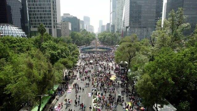 drone shot of people during pride parade at roundabout in mexico city