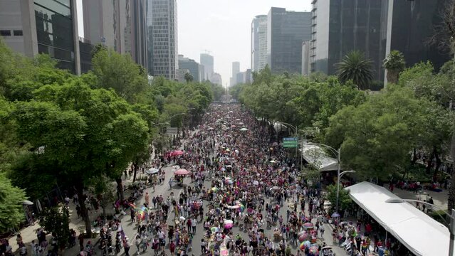 backwards drone shot of the pride parade in june in mexico city