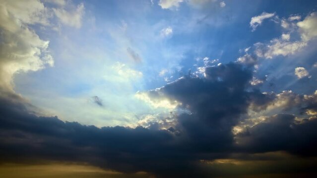Typhoon day in summer. Fast moving dark clouds and sun beams in blue sky. 4K sky clouds time lapse.
