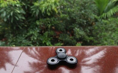 A fidget spinner resting on an open space